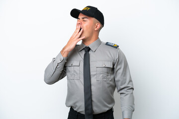 Young caucasian security man isolated on white background yawning and covering wide open mouth with...