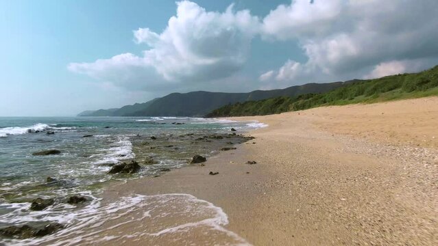 Low drone flight and riser over Amami Beach, Japan - pristine tropical coastline