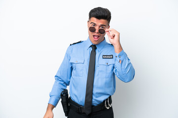 Young police caucasian man isolated on white background with glasses and surprised