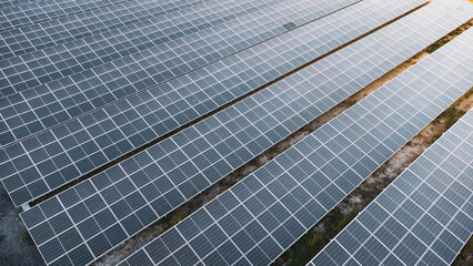 Fly over Solar cells on the roof of a large industrial factory. Solar roofs are generating...