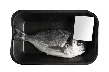 one fresh sea bream in black transparent black vacuum packaging with blank white label isolated on...