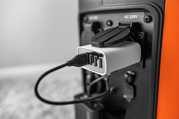 The inverter generator charges the power bank battery.