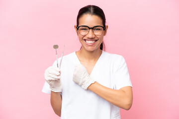 Dentist Colombian woman isolated on pink background celebrating a victory