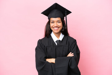 Young university Colombian woman graduate isolated on pink background keeping the arms crossed in...