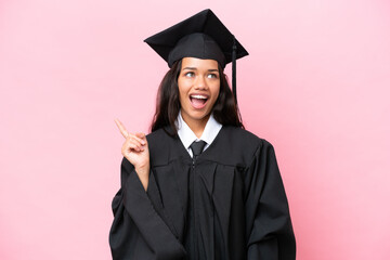 Young university Colombian woman graduate isolated on pink background thinking an idea pointing the...