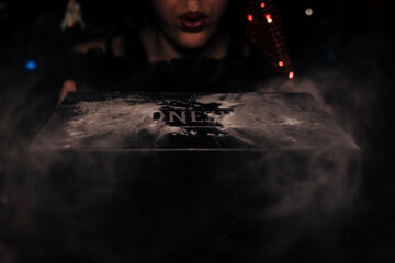 the girl blows dust from the box and the inscription Wednesday is visible there