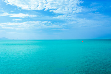 View of the sandy beach, summer sea and blue sky.