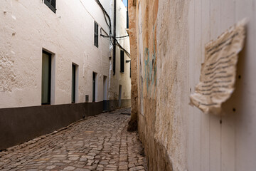 narrow street in the town - obrazy, fototapety, plakaty