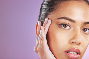 Fototapeta premium Skincare, beauty and woman with hands on face for cosmetics, beauty products and dermatology. Luxury spa, makeup and girl portrait on purple background for wellness, facial treatment and aesthetic
