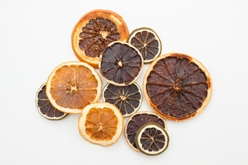 Pile of dried citrus circles lying on white table