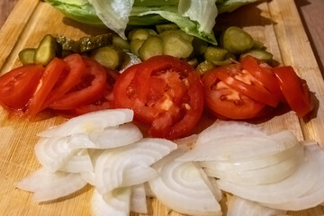 wooden board with tomatoes, onions and cucumbers