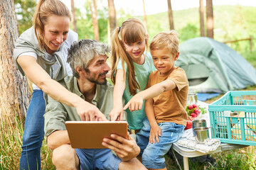 Family pointing at digital tablet held by man