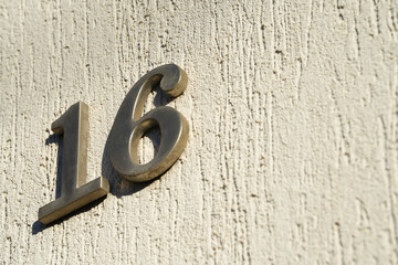 the number of a house mounted on its facade. detail.