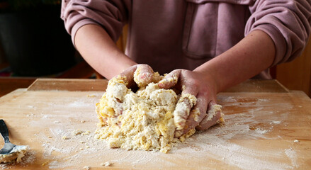 young caucasian female hands kneading shortcrust pastry for sweet tarte