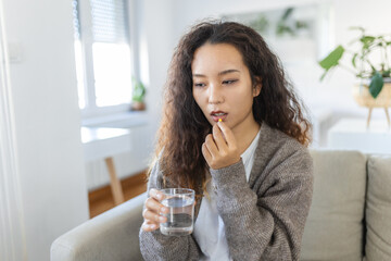 Asian woman takes medicines with glass of water. Daily norm of vitamins, effective drugs, modern pharmacy for body and mental health concept