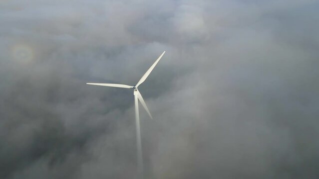 views of the wind farm from a height. Aerial View Of The Windmill In Fog. Drone shot