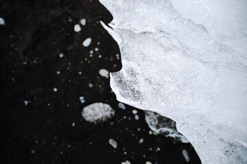 Chunks of ice washed up by the sea lie on the black beach of Breidamerkursandur ( Diamond Beach)....