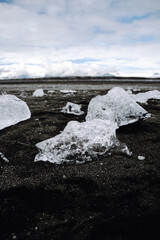 Chunks of ice washed up by the sea lie on the black beach of Breidamerkursandur ( Diamond Beach). They come from the broken icebergs from the glacier lagoon J&ouml;kuls&aacute;rl&oacute;n, which migrate into the sea.