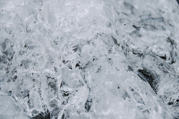 Chunks of ice washed up by the sea lie on the black beach of Breidamerkursandur ( Diamond Beach). They come from the broken icebergs from the glacier lagoon Jökulsárlón, which migrate into the sea.