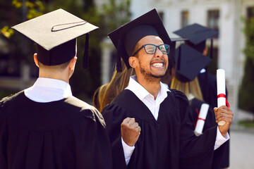 Yes, I did it. I got my degree. Cheerful, excited university student having fun at his graduation ceremony. Happy young African American man in an academic square cap celebrating his academic success