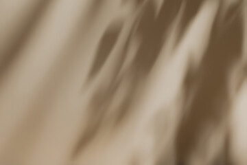 Fototapeta premium Abstract diagonal tree leaves shadows on solid beige wall texture. Abstract trendy colored nature concept background. Copy space for text overlay, poster mockup, flat lay, top view