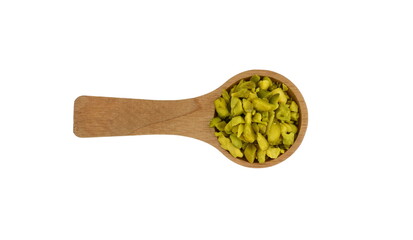 Chopped Pistachios in a wooden spoon  isolated on white Background. 