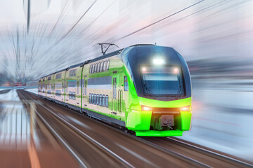 Electric passenger train drives at high speed among urban passenger station, motion blur effect.