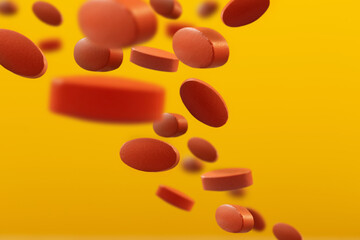 flying orange pills on yellow background