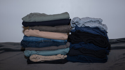 Stack of cotton colourful clothes indoors.Stacked apparel.Folded clean clothing.Household....