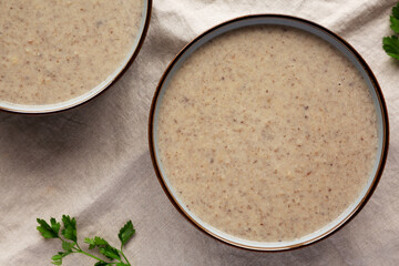 Homemade Cream of Mushroom Soup in a Bowl, top view. Flat lay, overhead, from above.