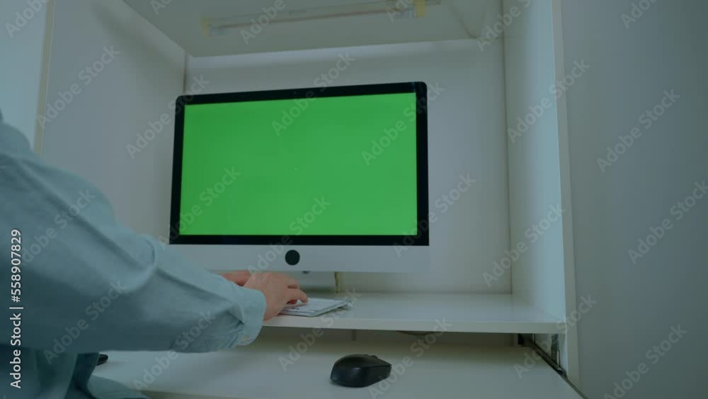 Poster working at home office man sitting at the desk typing on keyboard computer with green screen