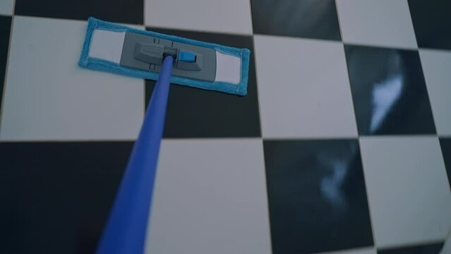 woman washing the floor at home close up mop