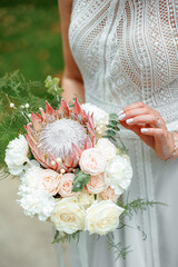 Wedding flowers. Bridal bouquet with exotic flowers. The bride is holding a bouquet. soft focus