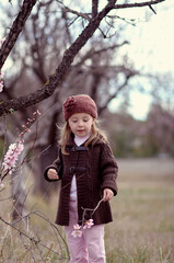 Portrait of a little girl with a branch of blossom