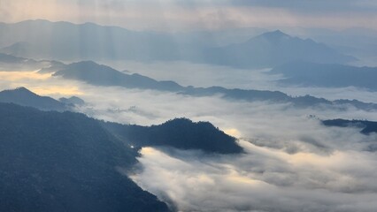 Fototapeta na wymiar Beautiful bird's-eye view of the sea of mist in the green mountain forest, Phu Chee Fah, Thoeng District, Chiang Rai, Thailand.