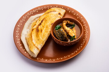 dosa with with fish curry from south Indian non vegetarian cuisine served in a plate