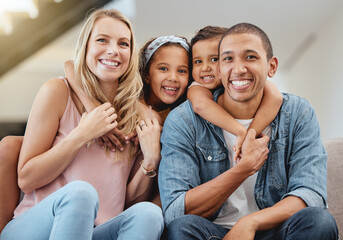 Kids, interracial and family on sofa for portrait, happy family and home together in Chicago, USA. Care, hug and smile of children embracing, happy mom and father with love, bonding and family home