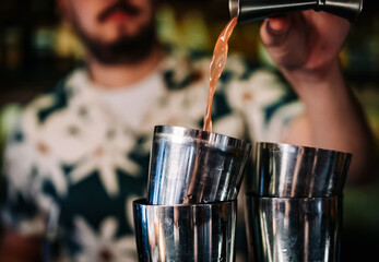 Fototapeta na wymiar man bartender making cocktail in bar