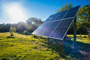 Solar energy panel installed in the field against bright sun, environmental equipment for the production of renewable energy, alternative source of clean electricity