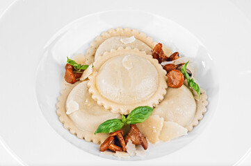 Portion of delicious vegetarian dumplings ravioli stuffed with chanterelle mushrooms, traditional Asian or Italian dish