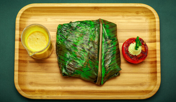 GoanFishRecheado curry is a popular hot and spicy baked fish recipe in banana leaves, Goa India. pearl spot fish is marinated with Masala Paste, Indian spices, wrapped in plantain leaf and grilled.