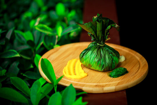 Kerala BEEF AND MUTTON KIZHI PARATHA MOR PORATTA IN BANANA LEAF ON A CIRCULAR WOODEN BAMBOO PLATE