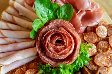 deli plate with salami rose and proscutto arranged with dried fig