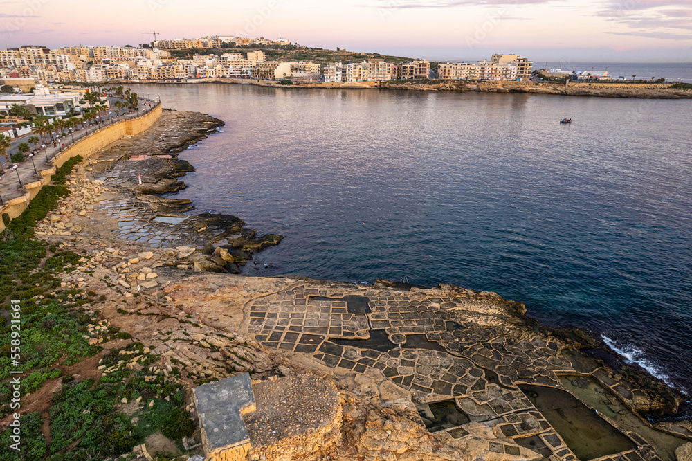 Wall mural salt pans in marsaskala, malta at sunrise