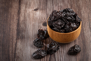 Bowl with prunes on the table.