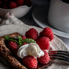 raspberry tart on chocolate puff pastry garnished with mint leaves
.