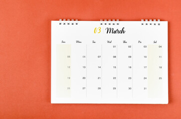 The March 2023 calendar desk for the organizer to plan and reminder on red background.