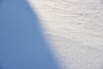 Snowy surface. White snow and snowdrifts in winter.