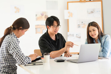 Construction design concept, Architects team is look house plan on laptop to discussing together