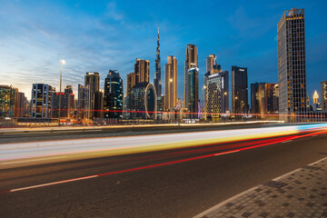 Fototapeta na wymiar Dubai city at night with light trails. Dubai city skyscrapers or skyline captured from Business Bay District, Dubai, UAE